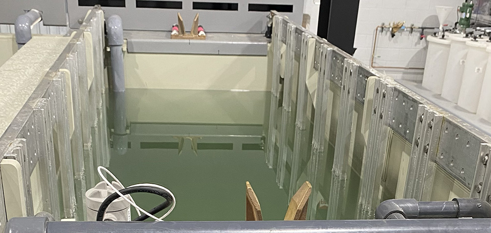 Array of 6063-T6 aluminum cathodes mounted on header bars for sulfuric acid anodizing.